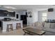 Open concept living space with dark cabinetry, a kitchen island, and comfortable seating at 108 San Avellino Ct, Bradenton, FL 34208