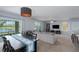Bright living area featuring a view of the lake and a cozy seating area with plush pillows at 108 San Avellino Ct, Bradenton, FL 34208