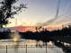 A pond with a fountain is reflecting the beautiful sunset colors at 108 San Avellino Ct, Bradenton, FL 34208