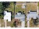Aerial view of property showcasing well-maintained lawn, mature landscaping, and the roof at 1112 67Th Nw St, Bradenton, FL 34209