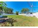 Fenced backyard with mature trees and an outbuilding for additional storage at 1112 67Th Nw St, Bradenton, FL 34209