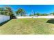 Large, fully fenced backyard with lush grass and mature trees at 1112 67Th Nw St, Bradenton, FL 34209