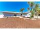 Inviting single-story home with a beautifully landscaped front yard, featuring palm trees, and a well-maintained lawn at 1112 67Th Nw St, Bradenton, FL 34209