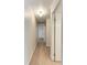 A bright hallway with wood flooring connects the living spaces at 1112 67Th Nw St, Bradenton, FL 34209