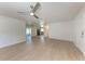 Open-concept living room with contemporary flooring, a modern ceiling fan, and a seamless flow to adjacent spaces at 1112 67Th Nw St, Bradenton, FL 34209
