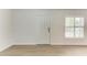 Bright, airy living room features wood-look flooring, a window with shutter-style blinds, and neutral walls at 1112 67Th Nw St, Bradenton, FL 34209