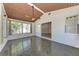 A sunroom with paneled ceiling and tiled floor leads to the rest of the home at 1112 67Th Nw St, Bradenton, FL 34209