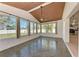 Bright sunroom featuring a wood paneled ceiling, tiled flooring, and ample windows offering a view to the outdoors at 1112 67Th Nw St, Bradenton, FL 34209