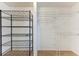 Open walk-in closet is ready for organizing with metal and wire shelving at 1112 67Th Nw St, Bradenton, FL 34209
