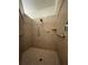 Tiled walk-in shower featuring grab bars, a shower head and built-in soap shelves at 11331 Bertolini Dr, Venice, FL 34292