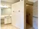 Modern bathroom boasts a tiled walk-in shower with grab bars and tiled floors at 11331 Bertolini Dr, Venice, FL 34292