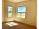 Cozy bedroom with carpeted floors and large windows showcasing serene lake views at 11331 Bertolini Dr, Venice, FL 34292