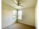 Cozy bedroom with neutral carpet, ceiling fan and two windows offering natural light at 11331 Bertolini Dr, Venice, FL 34292