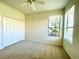 Bright bedroom features neutral carpet, double closet, and two windows offering natural light at 11331 Bertolini Dr, Venice, FL 34292