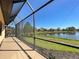Enjoy serene water views from this screened lanai overlooking the lush lawn at 11331 Bertolini Dr, Venice, FL 34292