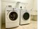 Spacious laundry room with sink, newer machines and built in storage at 11331 Bertolini Dr, Venice, FL 34292