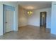 Spacious living room with tile flooring and elegant chandelier at 11331 Bertolini Dr, Venice, FL 34292