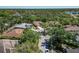 An aerial view showcases the quiet neighborhood surrounded by mature trees and the property's proximity to nearby lake at 11419 Pine Lilly Pl, Lakewood Ranch, FL 34202