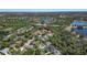 An aerial view captures this property's location within a community with nearby lakes and surrounded by lush greenery at 11419 Pine Lilly Pl, Lakewood Ranch, FL 34202