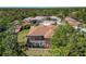 Aerial view showcases the property's layout including the pool and landscaping at 11419 Pine Lilly Pl, Lakewood Ranch, FL 34202