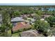 This aerial photo shows the property's backyard pool and surrounding mature landscaping near the nearby lake at 11419 Pine Lilly Pl, Lakewood Ranch, FL 34202