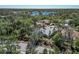 This aerial showcases a well-maintained community with mature trees, a scenic lake, and manicured lawns at 11419 Pine Lilly Pl, Lakewood Ranch, FL 34202