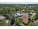 A bird's eye view highlights the property's screened-in pool and the surrounding neighborhood's proximity to the lake at 11419 Pine Lilly Pl, Lakewood Ranch, FL 34202