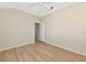 Well-lit bedroom shows flooring that extends into hallway with open doorway at 11419 Pine Lilly Pl, Lakewood Ranch, FL 34202
