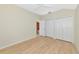 Bright bedroom features wood floors, a ceiling fan, and ample closet space at 11419 Pine Lilly Pl, Lakewood Ranch, FL 34202