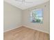 Windowed bedroom offers natural light and views of the yard and landscaping at 11419 Pine Lilly Pl, Lakewood Ranch, FL 34202