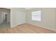 Bedroom featuring wood floors, a double closet, and a bright window at 11419 Pine Lilly Pl, Lakewood Ranch, FL 34202