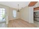 Inviting dining area with wood floors, chandelier lighting, and natural light at 11419 Pine Lilly Pl, Lakewood Ranch, FL 34202