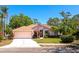 Charming single-story home with a well-maintained lawn, mature trees and a two-car garage at 11419 Pine Lilly Pl, Lakewood Ranch, FL 34202