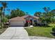 Inviting home with a 2-car garage, beautiful landscaping, and a well-maintained lawn that adds to the appeal at 11419 Pine Lilly Pl, Lakewood Ranch, FL 34202