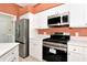Modern kitchen featuring stainless steel appliances and white cabinets at 11419 Pine Lilly Pl, Lakewood Ranch, FL 34202