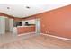 Open-concept living area leading to kitchen and outdoor lanai at 11419 Pine Lilly Pl, Lakewood Ranch, FL 34202