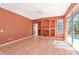 Living room with a sliding glass door and built-in shelving at 11419 Pine Lilly Pl, Lakewood Ranch, FL 34202