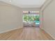 Sunlit room showcasing wood floors with expansive sliding doors leading to the pool at 11419 Pine Lilly Pl, Lakewood Ranch, FL 34202