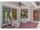 Covered patio seating area that overlooks the screened pool at 11419 Pine Lilly Pl, Lakewood Ranch, FL 34202