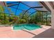 Screened-in backyard pool surrounded by greenery at 11419 Pine Lilly Pl, Lakewood Ranch, FL 34202