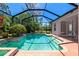 Backyard screen enclosed pool with lush landscaping at 11419 Pine Lilly Pl, Lakewood Ranch, FL 34202