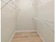 An organized walk-in closet with shelves and wood floor at 11419 Pine Lilly Pl, Lakewood Ranch, FL 34202
