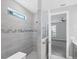 A modern bathroom features glass shower door and sleek fixtures at 11717 Blue Hill Trl, Lakewood Ranch, FL 34211