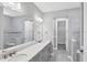A modern bathroom with a double vanity and walk in closet at 11717 Blue Hill Trl, Lakewood Ranch, FL 34211