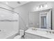 Bathroom with double vanity, quartz countertop, and a tub with white subway tile surround at 11717 Blue Hill Trl, Lakewood Ranch, FL 34211