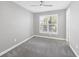 A peaceful bedroom gets natural light through a large window at 11717 Blue Hill Trl, Lakewood Ranch, FL 34211