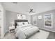 A serene bedroom is decorated in light neutral tones, and gets natural light through the windows at 11717 Blue Hill Trl, Lakewood Ranch, FL 34211
