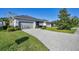 Paver driveway leads to a well-maintained home with a two-car garage and lush landscaping at 11717 Blue Hill Trl, Lakewood Ranch, FL 34211