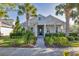 Charming single-story home featuring lush landscaping, a brick pathway, and a welcoming covered porch at 11717 Blue Hill Trl, Lakewood Ranch, FL 34211