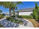Charming front yard with manicured landscaping, walkway, and palm trees enhances curb appeal at 11717 Blue Hill Trl, Lakewood Ranch, FL 34211